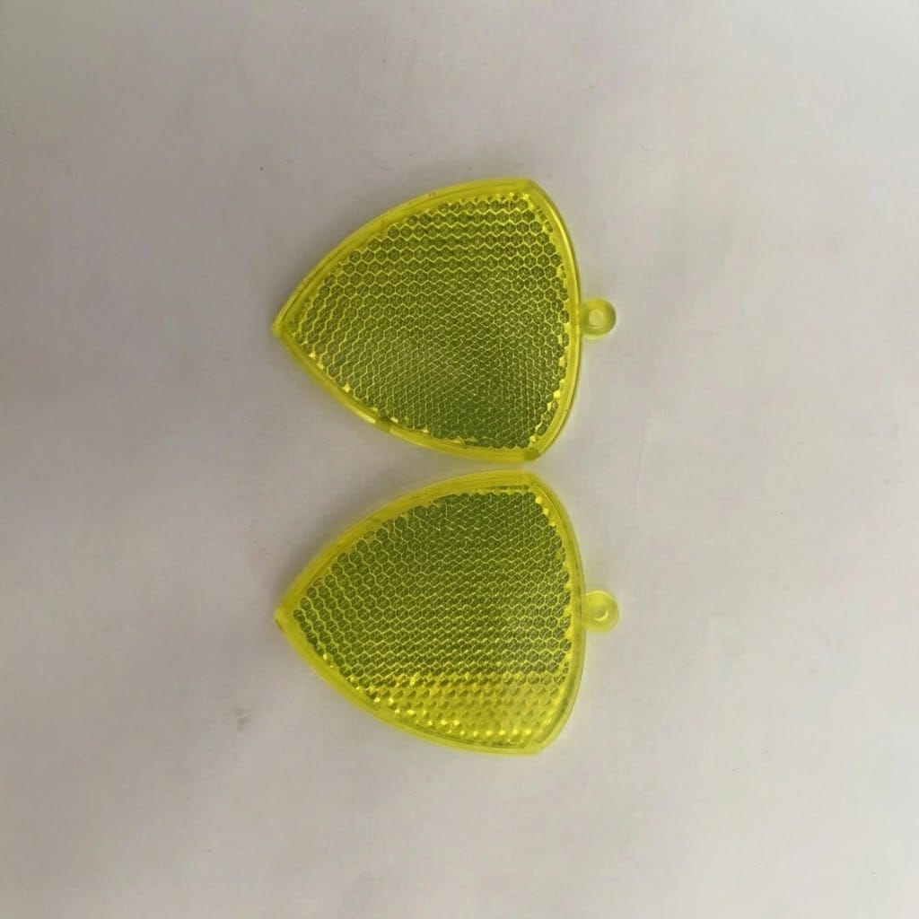 High-visibility yellow hard safety reflector made from optical grade PMMA, displaying bright honeycomb pattern under light.