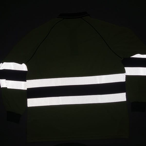 reflective workwear test showing high visibility polo shirt glowing under flash light