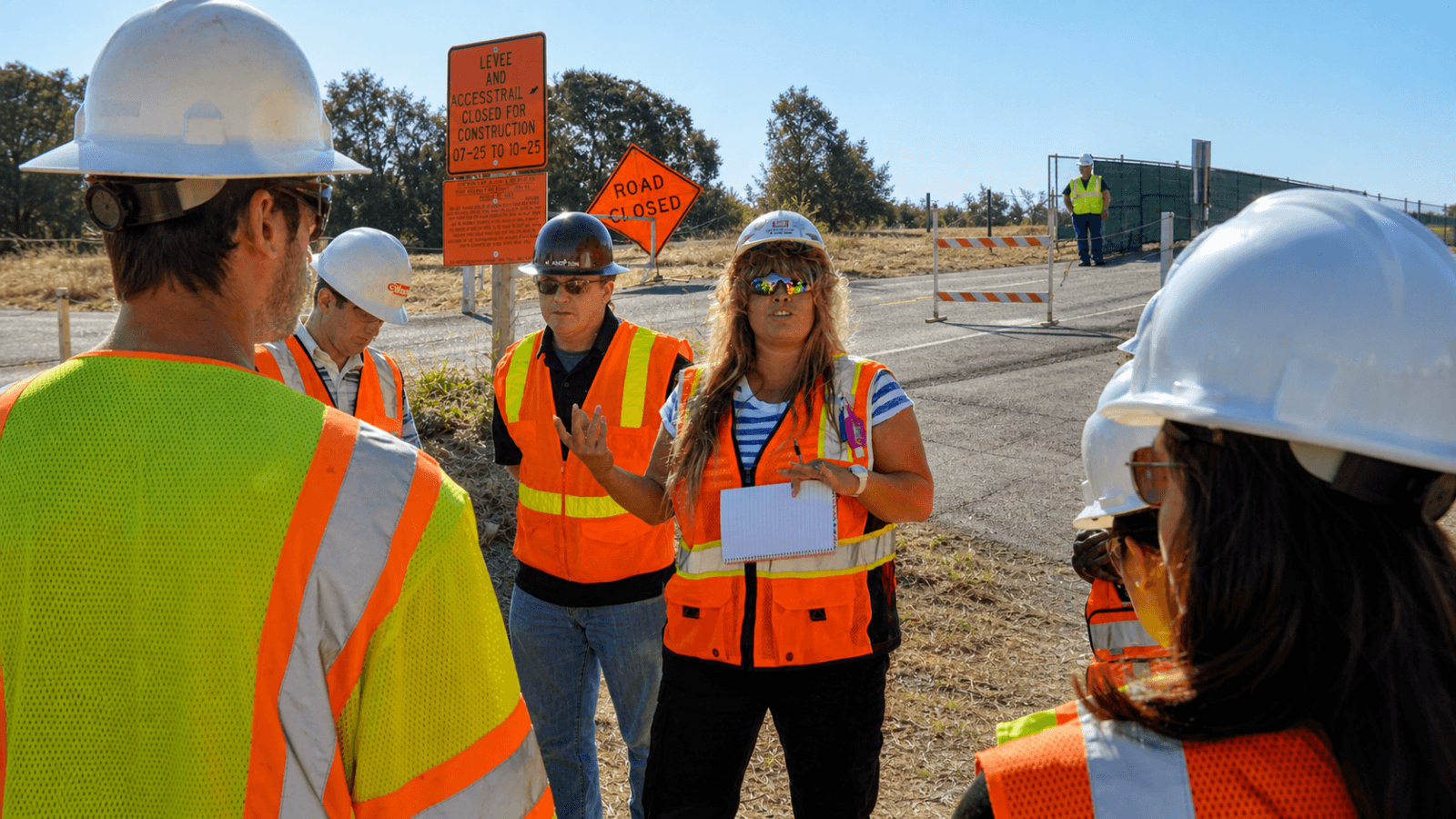 Construction crew wearing high-visibility safety apparel during a work-zone briefing