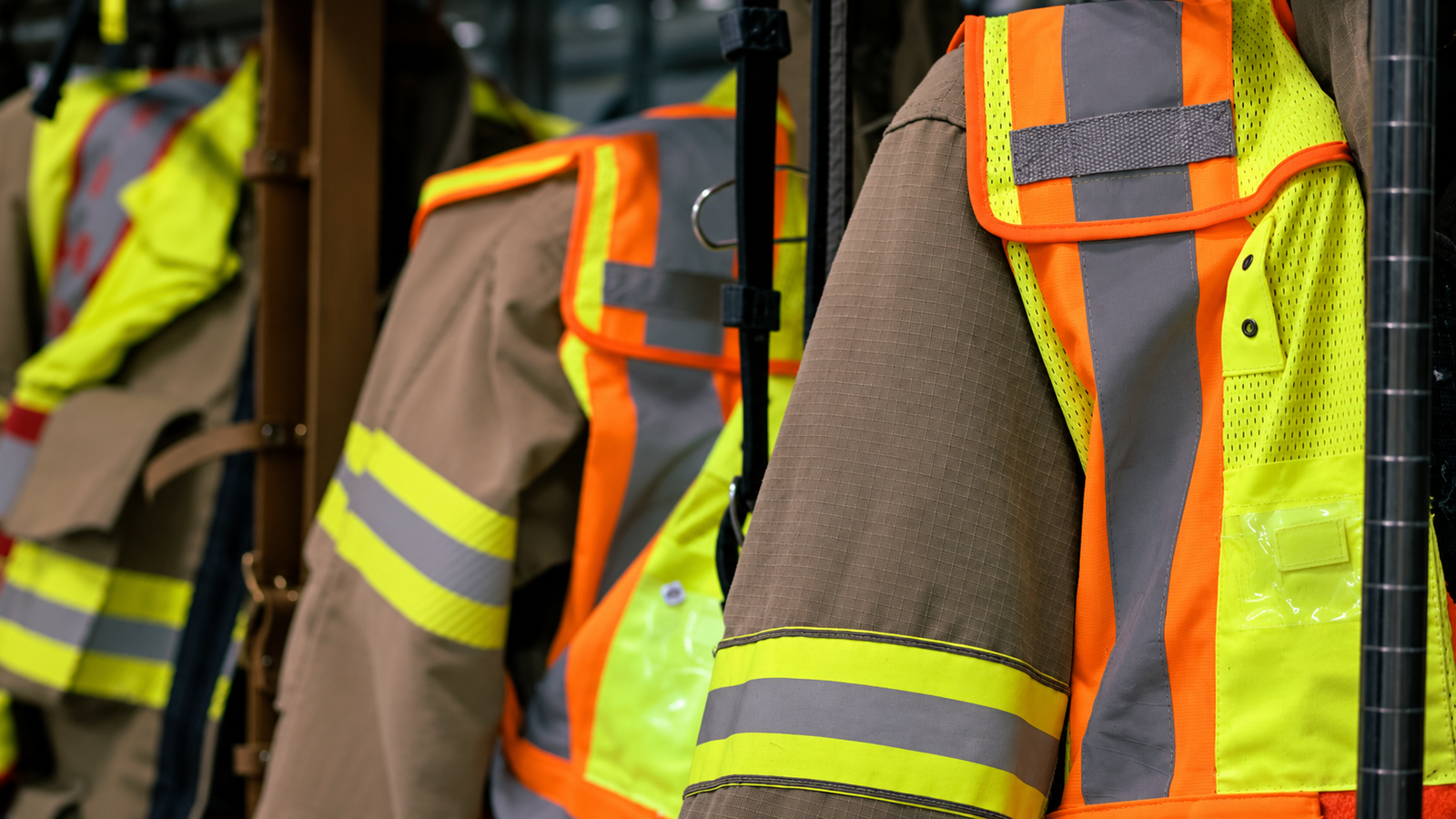 Sewn reflective tape on hanging protective jackets and hi-vis vests